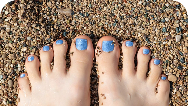 Beautiful female feet with blue glitter pedicure