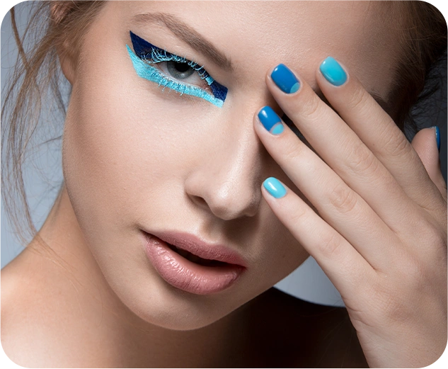 Beautiful girl with bright creative fashion makeup blue nail polish