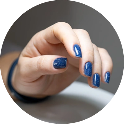 Client holds his hand stand with blue gel polish applied nails